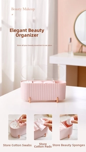 Close-up of pink makeup organizer with gold legs and compartments for cotton pads