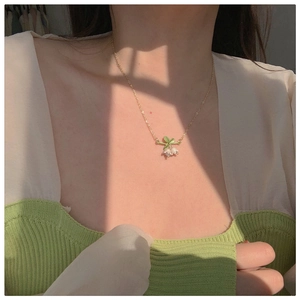 Macro detail of lily of the valley necklace on model under natural sunlight