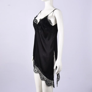 Detail of black satin camisole showing intricate eyelash lace trim and asymmetric hem