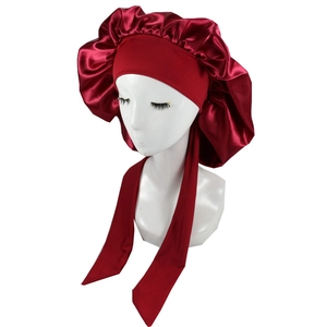 Close-up of burgundy satin bonnet featuring wide elastic band and long straps for long hair