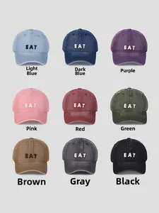 Detailed grid of nine washed denim baseball caps with EAT embroidery in various colors