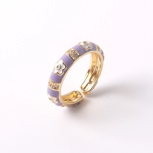 Detailed close-up of 18K gold plated flower ring with purple enamel and zircon inlay