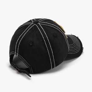 Black canvas baseball cap with white contrast stitching and distressed brim detail