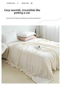 Detailed view of cream waffle weave texture and fashion label on soft flannel blanket