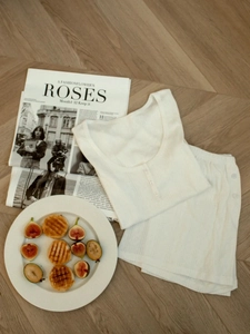 Detailed view of cream rib-knit pajama set featuring buttons and vertical texture