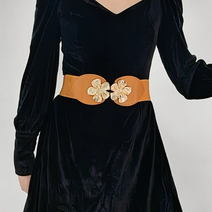 Detail of a brown leather belt featuring double golden peach blossom metal buckles