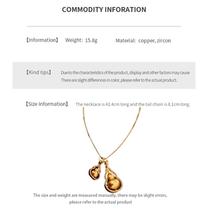 Macro view of gold-plated copper double gourd pendant with zircon inlay and dimensions