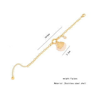 Detail of stainless steel gold bracelet with shell starfish pendant and dimension text