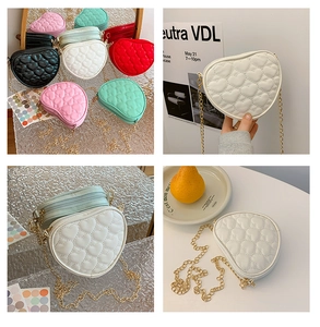 Close-up of heart-shaped quilted PU leather bags with elegant gold chain straps