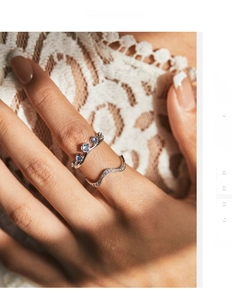 Close-up of S925 sterling silver crown ring set with blue gemstones and wavy band