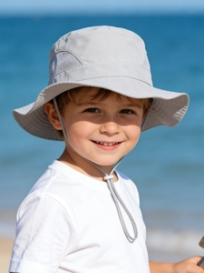 Detail view of breathable mesh zones and adjustable windproof strap on kids sun hat