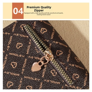 Detail of high-quality metal zipper with golden heart-shaped puller on printed leather bag