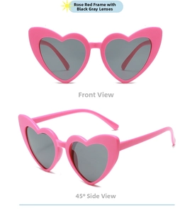 Detail view of heart-shaped sunglasses with rose red frames and black grey lenses