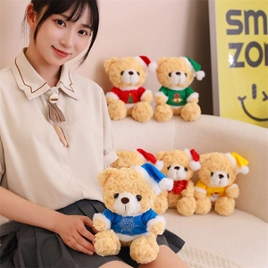 Detailed view of plush teddy bears in colorful snowflake Christmas sweaters and hats