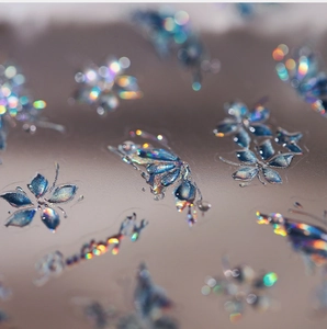 Macro view of iridescent laser butterfly nail art stickers with 3D holographic effect