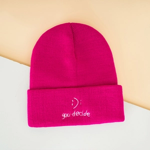 Pink smiley face knit beanie with embroidered 'you decide' phrase for winter warmth