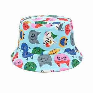 Close-up of the cartoon cat print and reinforced stitching on the blue cotton bucket hat