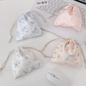 Detail shot of four cute cartoon drawstring storage pouches for cosmetics and toiletries