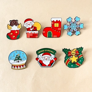 Colorful Christmas enamel lapel pins set with Santa, snowflake, and bear on metal badges