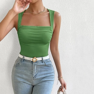 Close-up of green ribbed knit tank top with square neck and slim fit on a model