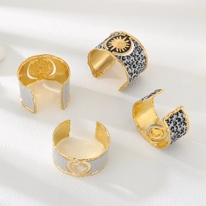 Golden wide cuff bracelets with celestial sun moon motifs and leopard textured finish