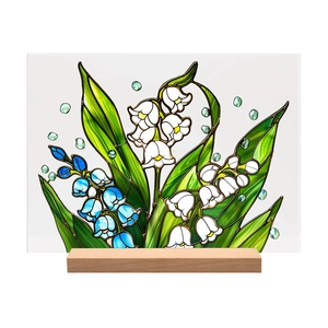 Detail of lily of the valley acrylic decor with blue flowers and a natural wooden base