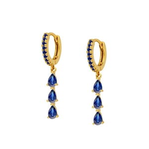 Detail of gold hoop earrings with tiered blue pear-cut crystals and pavé setting