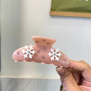 Pink acetate hair claw clip with snowflake crystals and small pink rhinestones for women