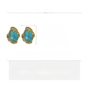 Detailed view of turquoise resin earrings with golden wavy metal base and 2.2x1.7cm size