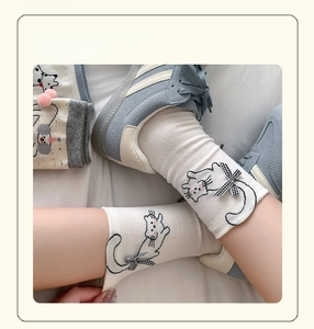 Detail of cute cat pattern socks with bow tie, soft elastic and breathable cotton fabric