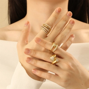 Detail of three 18K gold plated multi-layer rings with zircon on a model's hand