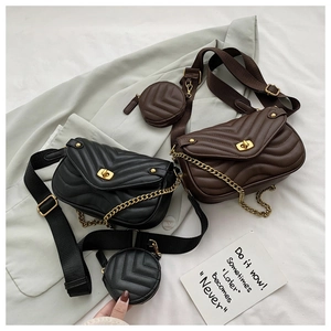 Detail of V-quilted chain bags in black and mocha brown with detachable wide straps