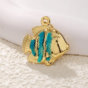 Macro detail of gold-plated fish pendant with blue enamel finish for DIY jewelry