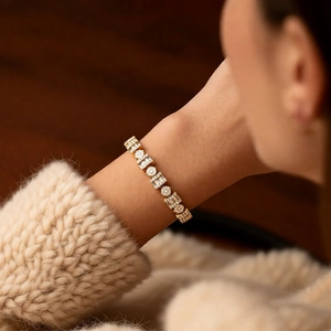 Close-up of 18k gold plated vintage bracelet with crystals on a knitted sleeve