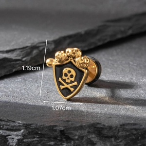 Macro view showing dimensions of golden stainless steel skull shield stud earring