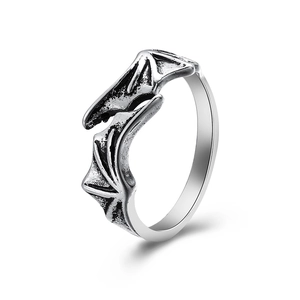 Detailed close-up of retro silver bat wing ring with textured gothic metal finish