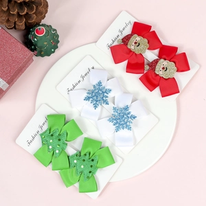 Detailed view of red, white and green Christmas bow hair clips on display cards