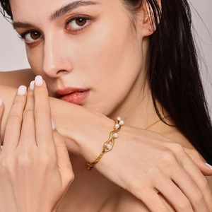 18K gold plated C-shaped cuff bracelet with wavy design and elegant white pearls