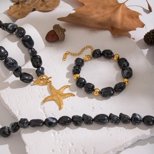 Irregular black resin bead necklace and bracelet set with golden starfish pendant charms