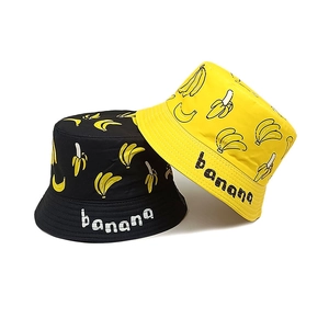 Close-up of kids' double-sided cotton bucket hats with banana prints and text