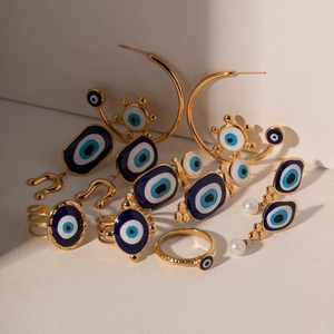 Evil Eye jewelry set with blue charms and pearls in gold finish earrings and rings