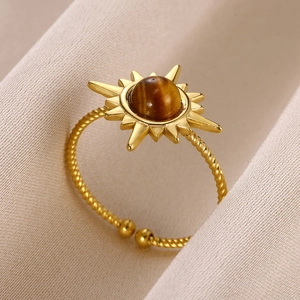 Detailed close-up of golden sunflower ring with tiger eye stone and spiral band