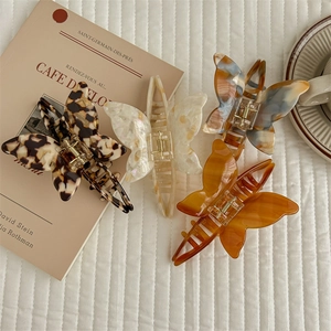 Set of four acetic acid butterfly hair claws in leopard, pearl, blue and amber patterns