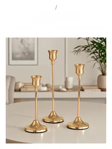 Detailed view of three-piece golden iron candle holder set with non-slip base mats