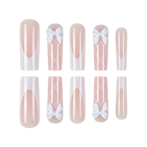 Pink balletcore press-on nails with white French tips, 3D bows, and ribbon details