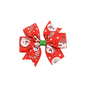 Detail of Christmas snowman print ribbon bow hair clip with red and green festive colors