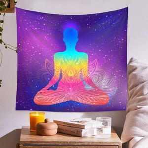 Detail of meditation tapestry with rainbow silhouette and lotus mandala on a starry wall