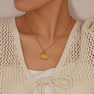 Minimalist gold shell pendant necklace with ball chain on model for summer beach style