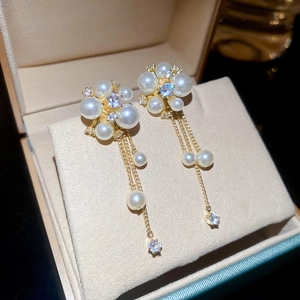 Macro detail of French vintage pearl tassel earrings with zircon studs in jewelry box