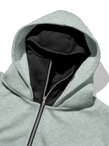 Detailed macro view of the metal zipper and windproof high collar on a gray hoodie